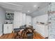 A cozy dining area features a small table with barstool seating, set against a brick wall and wooden floors at 1855 W West River Rd, Franklinton, NC 27525