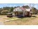 Charming home with metal roof, covered porch, and manicured lawn at 1855 W West River Rd, Franklinton, NC 27525