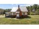 Charming single-story home with brick accents, a metal roof, and a quaint covered front porch at 1855 W West River Rd, Franklinton, NC 27525