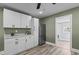 Kitchen featuring stainless steel refrigerator, white cabinets and hardware, and wooden floors at 1855 W West River Rd, Franklinton, NC 27525