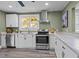 Charming kitchen showcasing stainless steel appliances and crisp white cabinetry at 1855 W West River Rd, Franklinton, NC 27525