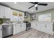 Bright kitchen features stainless steel appliances, white cabinets, and modern countertops at 1855 W West River Rd, Franklinton, NC 27525