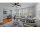 The living room offers lots of seating, a ceiling fan, and natural light from two windows at 1855 W West River Rd, Franklinton, NC 27525