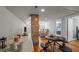 Inviting space with a dining area leading to a living room, featuring hardwood floors and neutral decor at 1855 W West River Rd, Franklinton, NC 27525