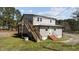 Two-story home featuring wood siding and a deck with stairs leading to the ground at 1855 W West River Rd, Franklinton, NC 27525