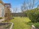 Green backyard featuring grass, a fence, planting beds, and a wooden arbor at 200 Indian Branch Dr, Morrisville, NC 27560