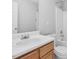 Bathroom with a single sink, white cabinets, tub and toilet at 200 Indian Branch Dr, Morrisville, NC 27560