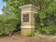 Stone sign marking the entrance to Downing Glen, surrounded by greenery at 200 Indian Branch Dr, Morrisville, NC 27560