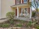 Inviting front porch with chairs, garden area, and vibrant pops of color at 200 Indian Branch Dr, Morrisville, NC 27560