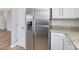 Stainless steel refrigerator with granite countertops and white cabinets at 200 Indian Branch Dr, Morrisville, NC 27560