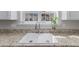 Close up view of a kitchen sink with granite countertops, a stylish faucet, and natural light at 200 Indian Branch Dr, Morrisville, NC 27560