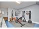 Finished basement with weight training station, exercise bike and mirrored wall at 203 Valleyshire Rd, Durham, NC 27707