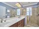 Bright bathroom with a double sink vanity and a large glass enclosed shower at 203 Valleyshire Rd, Durham, NC 27707
