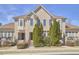 Charming townhome exterior featuring brick facade, bay windows, and well-maintained landscaping at 203 Valleyshire Rd, Durham, NC 27707