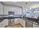 Modern kitchen featuring granite countertops, stainless steel appliances, and ample cabinet space at 203 Valleyshire Rd, Durham, NC 27707