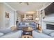 Open-concept living area flowing into the kitchen, featuring hardwood floors and a fireplace at 203 Valleyshire Rd, Durham, NC 27707
