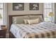 Comfortable main bedroom with natural lighting, calming colors, and plush bedding at 203 Valleyshire Rd, Durham, NC 27707