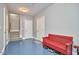 Bright mudroom with a red bench, shoe storage and a staircase at 203 Valleyshire Rd, Durham, NC 27707