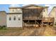 Exterior back of the house with screened in deck and wooden deck at 205 Quarryrock Rd, Holly Springs, NC 27540