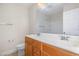 Bathroom with dual sinks, wood cabinets, and a toilet at 205 Quarryrock Rd, Holly Springs, NC 27540