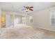 Bright bedroom featuring columns, a ceiling fan, an open stairway and lots of natural light at 205 Quarryrock Rd, Holly Springs, NC 27540