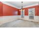 Formal dining room with chair rail, chandelier and large windows providing ample natural light at 205 Quarryrock Rd, Holly Springs, NC 27540