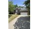 Traditional two-story red brick home with an attached two-car garage and manicured lawn at 205 Quarryrock Rd, Holly Springs, NC 27540