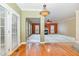Inviting living room area with hardwood floors, an elegant chandelier and views into another room at 205 Quarryrock Rd, Holly Springs, NC 27540