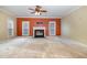 Spacious living room features a cozy fireplace and large windows for ample natural light at 205 Quarryrock Rd, Holly Springs, NC 27540