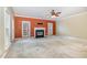 Large living room area featuring a fireplace, ceiling fan, and an abundance of natural light at 205 Quarryrock Rd, Holly Springs, NC 27540