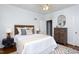 Cozy bedroom featuring neutral walls, hardwood floors, ceiling fan, and decorative mirror at 205 W Markham Ave, Durham, NC 27701