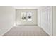 Light and bright bedroom featuring neutral carpet, trim and paint and large windows and closet at 207 Alumni Ave, Durham, NC 27713