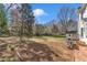 Large backyard with mature trees, a grill, and brick accents at 207 Lewey Brook Dr, Cary, NC 27519