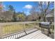 This backyard deck has a Traeger grill and offers an exceptional view of the beautiful yard at 207 Lewey Brook Dr, Cary, NC 27519