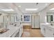 Luxurious bathroom with dual vanities, skylights, and separate tub at 207 Lewey Brook Dr, Cary, NC 27519