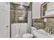 Bathroom featuring a walk-in tub with shower, mosaic tile details, and framed mirror at 207 Lewey Brook Dr, Cary, NC 27519