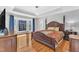 Primary bedroom with tray ceiling, bay window, and hardwood floors at 207 Lewey Brook Dr, Cary, NC 27519