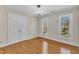 The bedroom includes hardwood floors, two windows, a ceiling fan, and a closet at 207 Lewey Brook Dr, Cary, NC 27519