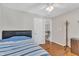 The bedroom offers a view of the staircase, wood floors, and a comfortable bed at 207 Lewey Brook Dr, Cary, NC 27519