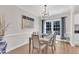 The dining room offers natural light, hardwood floors, and modern chandelier at 207 Lewey Brook Dr, Cary, NC 27519
