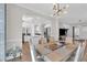 Elegant dining room with stylish lighting fixture and open access to the kitchen at 207 Lewey Brook Dr, Cary, NC 27519