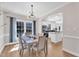 Bright dining room features modern light fixture and natural light with an open view into the spacious kitchen at 207 Lewey Brook Dr, Cary, NC 27519