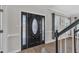 The foyer features a decorative front door, hardwood floors, and elegant staircase at 207 Lewey Brook Dr, Cary, NC 27519