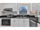 Updated kitchen with stainless appliances, granite countertops, and ample natural light from the window above the sink at 207 Lewey Brook Dr, Cary, NC 27519