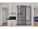 Modern kitchen with white cabinets, stainless steel fridge, and granite countertops at 207 Lewey Brook Dr, Cary, NC 27519