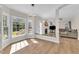 Bright open living room with large windows, fireplace and modern lighting at 207 Lewey Brook Dr, Cary, NC 27519