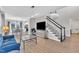 Open-concept living room with hardwood floors, staircase, and ample natural light at 207 Lewey Brook Dr, Cary, NC 27519