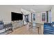 Comfortable living room with large television, hardwood floors, and access to foyer at 207 Lewey Brook Dr, Cary, NC 27519