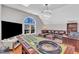 This living room contains a roulette table, couch, desk, modern light, and a hardwood floor at 207 Lewey Brook Dr, Cary, NC 27519