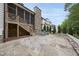 Spacious backyard with a large stone patio, screened porch, and beautifully landscaped yard at 2073 Amalfi Pl, Apex, NC 27502